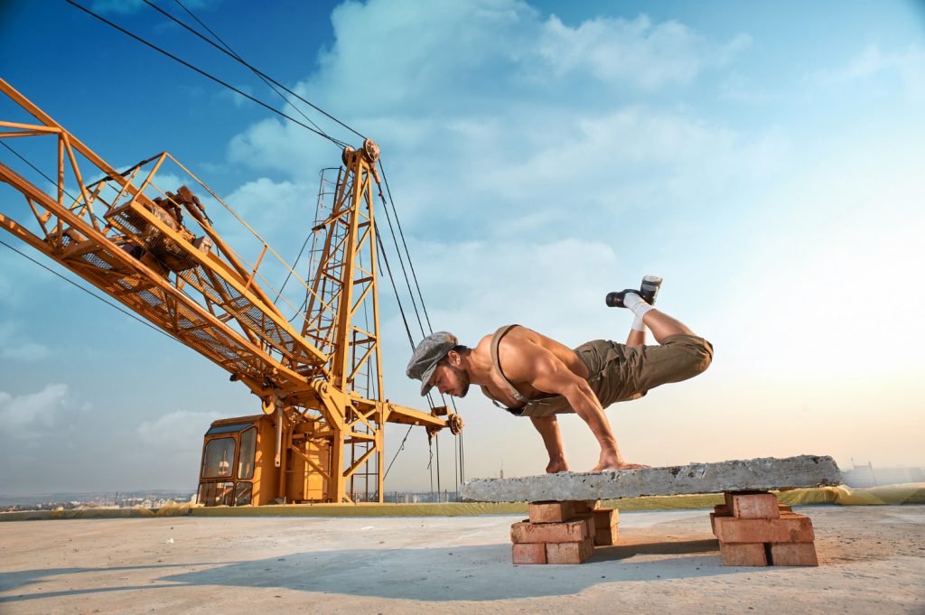 Man performing push-ups on concrete
